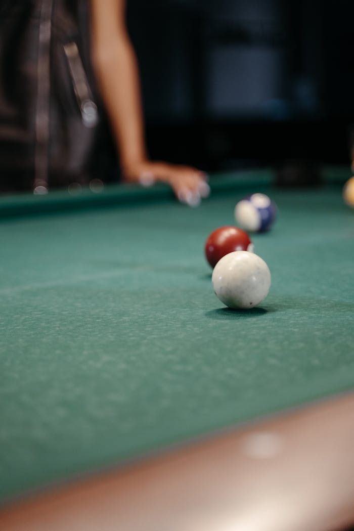 Focused shot of billiard balls on a pool table, ideal for sports and leisure themes.